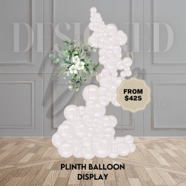 Set of display plinths decorated with balloons and flowers for a chic, elevated event setup